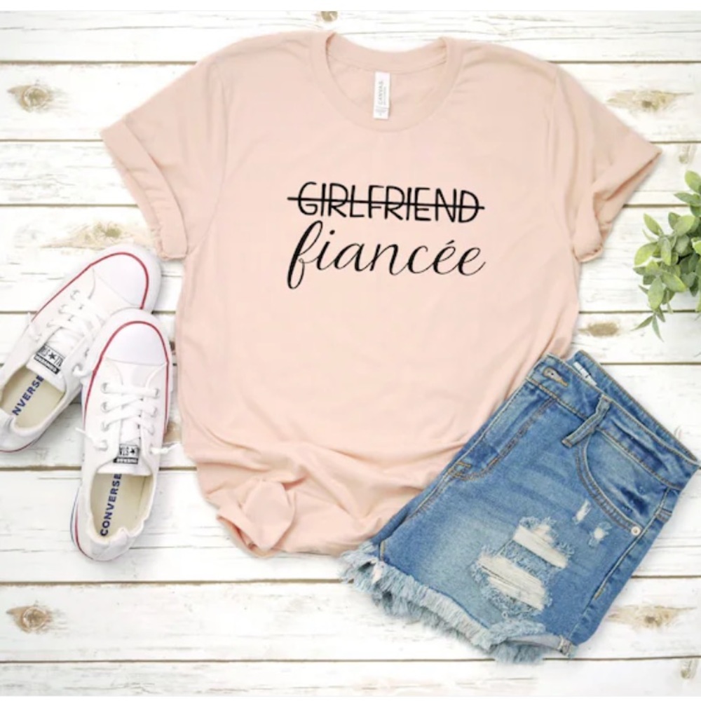 Never worn “Girlfriend to Fiancee” T-shirt. Size small. Pink.